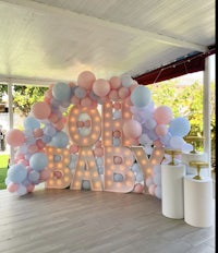 a baby shower with balloons and a sign that says oh baby