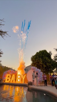 a baby shower with fireworks and a sign that says baby